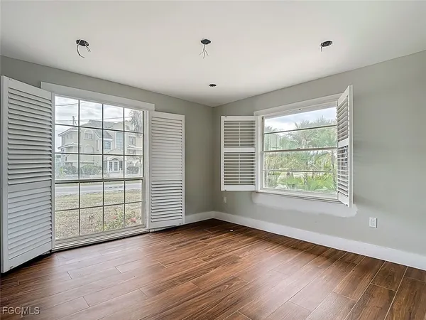 wooden floor in an empty room with a window