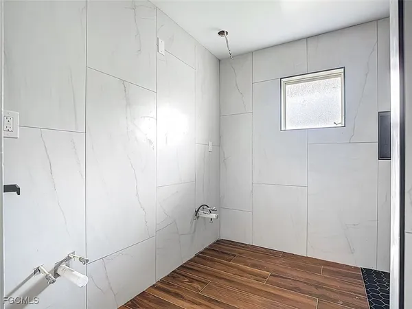 a bathroom with a window and a shower