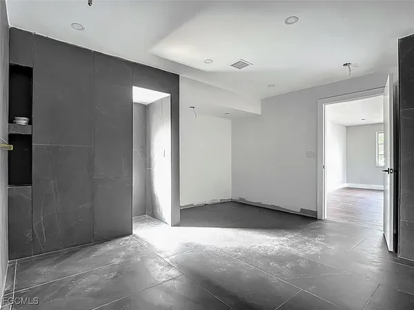 an empty room with closet and a bathroom