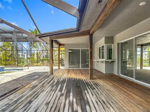 a view of outdoor space with wooden floor and windows