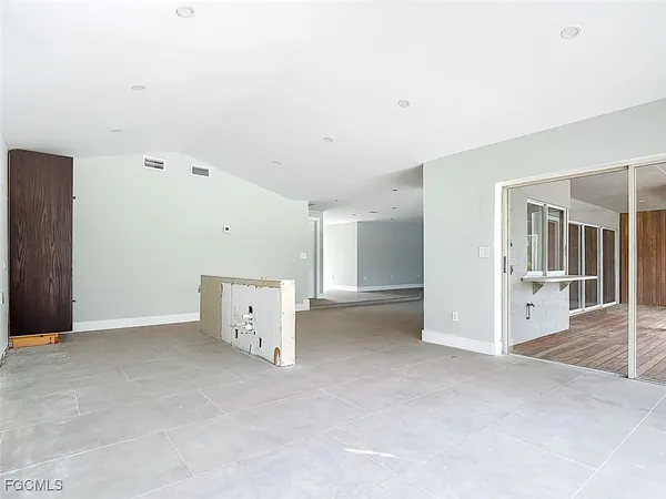 an empty room with closet and windows