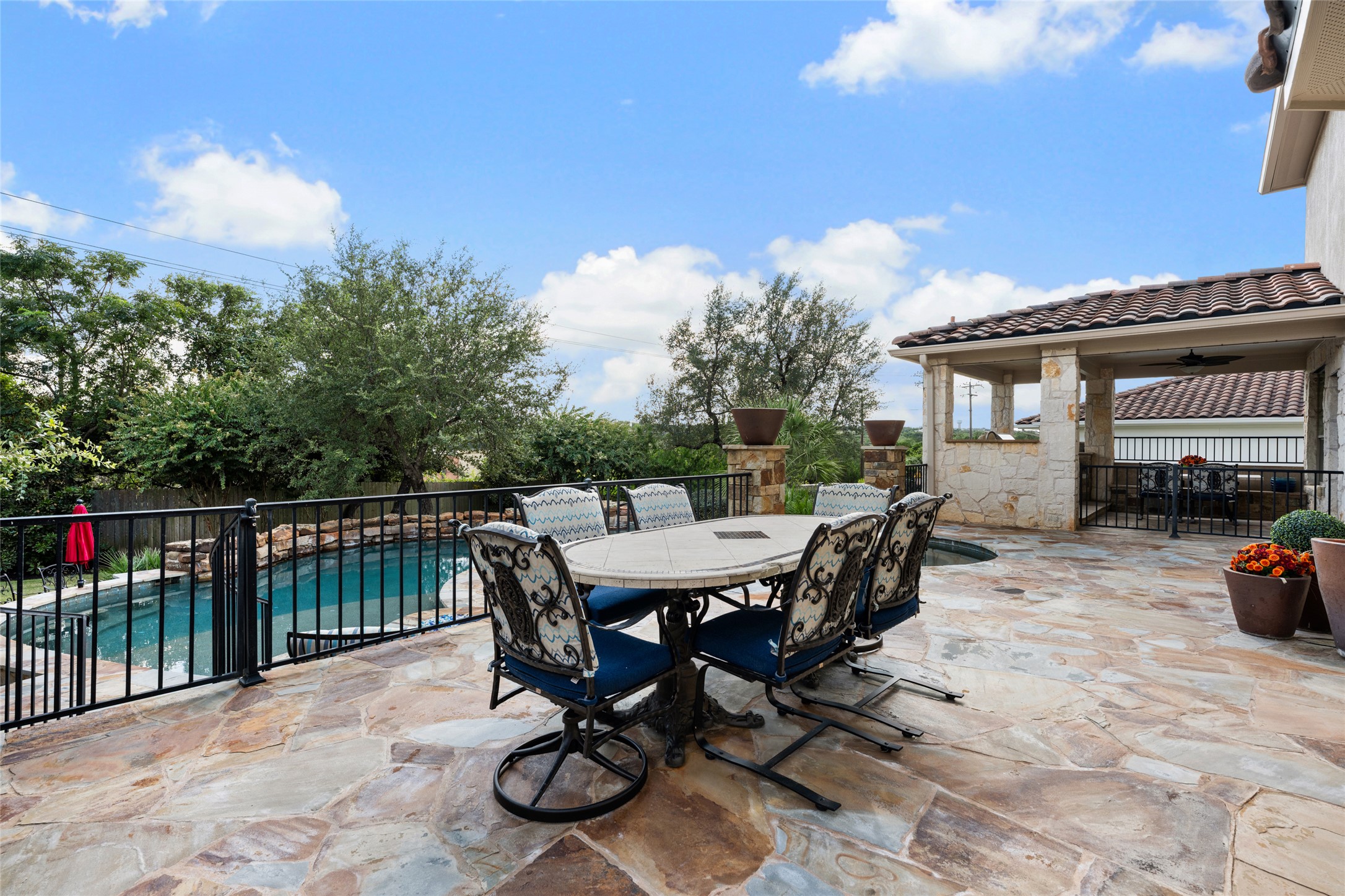 15205 Spillman Ranch Loop Austin, TX 78738 - Photo 5 of 40 An inviting stone patio offers ample space for outdoor dining and relaxation by the private swimming pool.