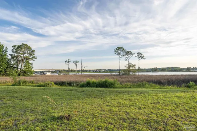 a view of a lake with houses in the back