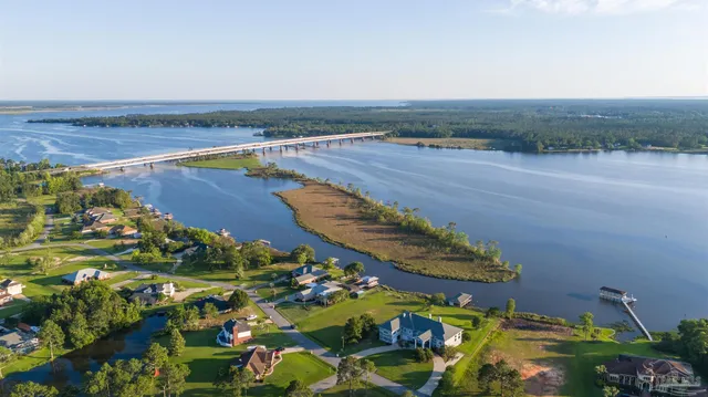an aerial view of a house yard and lake view