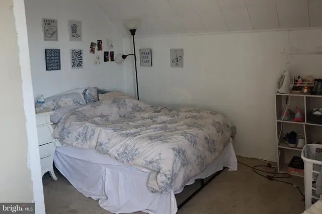 a bedroom with a bed and dresser