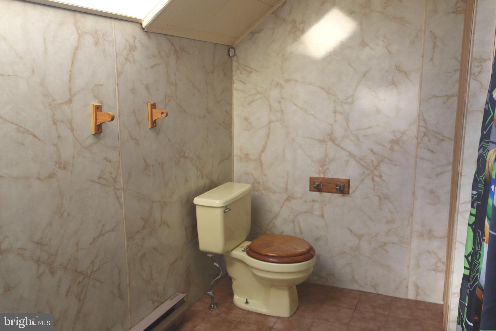 121 Patterson Avenue Bellmawr, NJ 08031 - Photo 15 of 20 a white toilet sitting next to a white sink and vanity