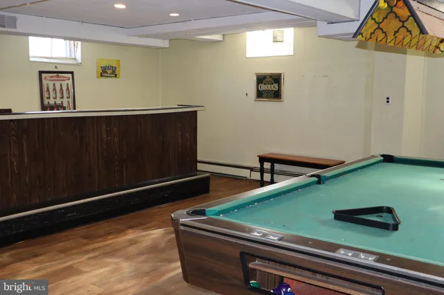 a room with furniture pool table and window