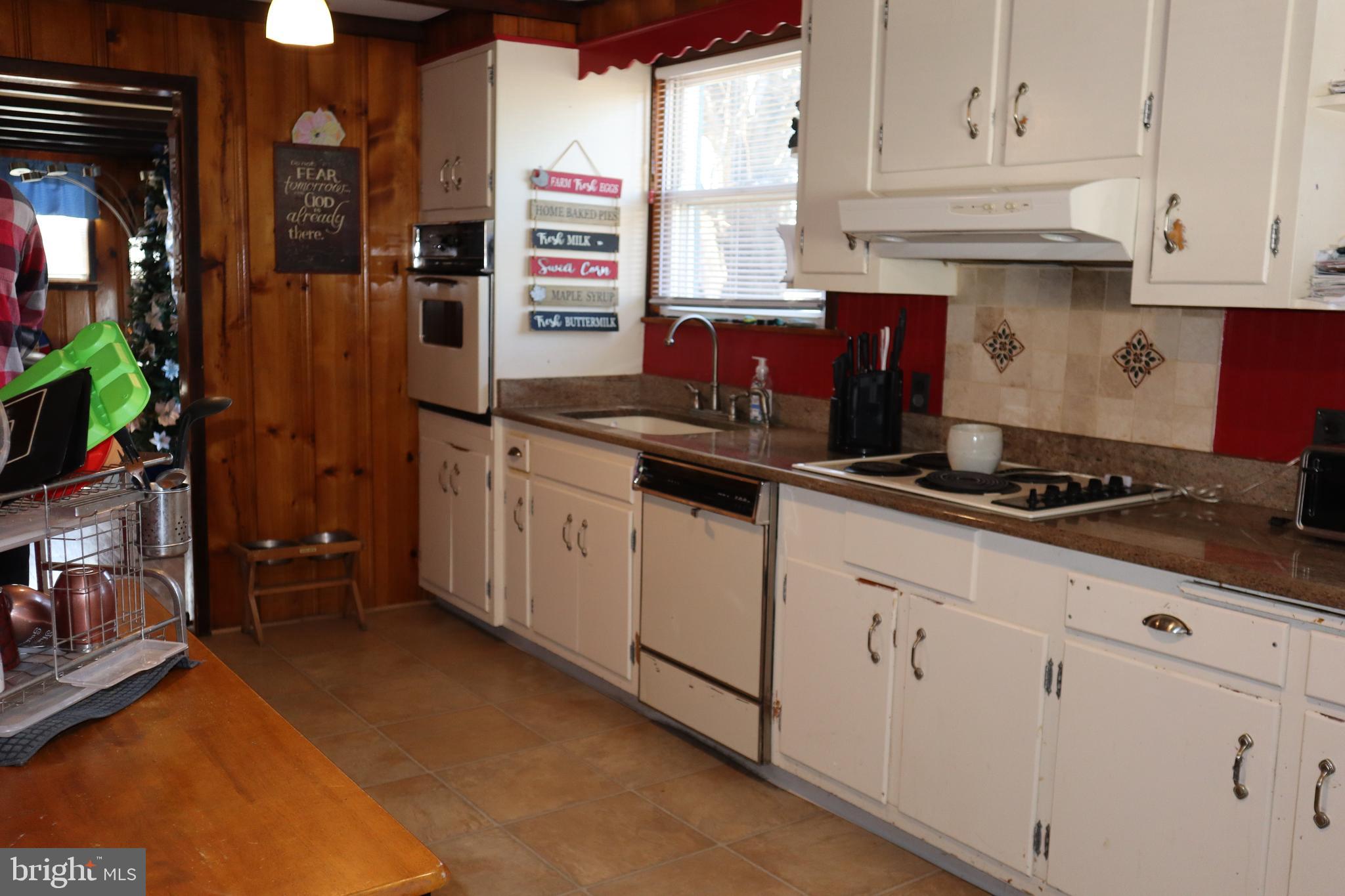 121 Patterson Avenue Bellmawr, NJ 08031 - Photo 5 of 20 a kitchen with stainless steel appliances granite countertop a stove a sink and a white cabinets