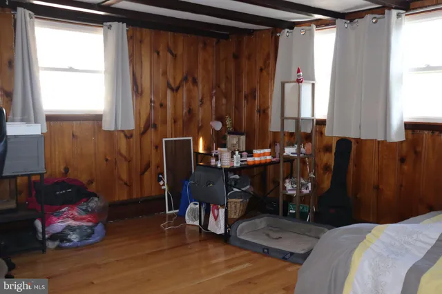 a bed room with a bed window and a chair