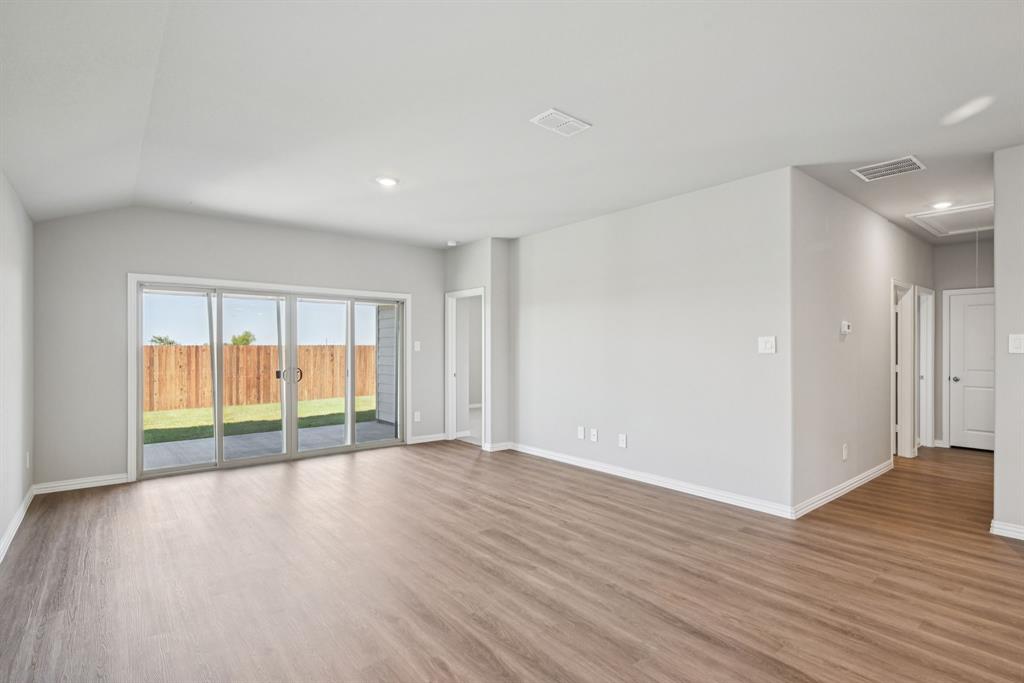 2112 Rannoch Street Sherman, TX 75092 - Photo 11 of 32 a view of an empty room with wooden floor and a window