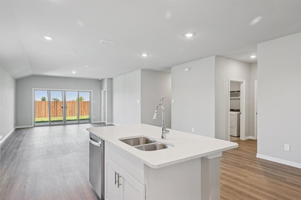 2112 Rannoch Street Sherman, TX 75092 - Photo 14 of 32 a kitchen with a sink and a refrigerator