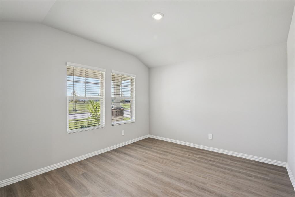2112 Rannoch Street Sherman, TX 75092 - Photo 15 of 32 an empty room with wooden floor and windows