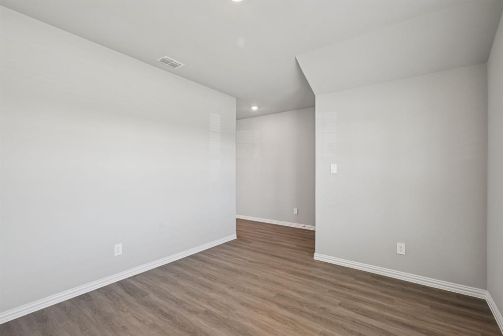 2112 Rannoch Street Sherman, TX 75092 - Photo 16 of 32 a view of an empty room with wooden floor