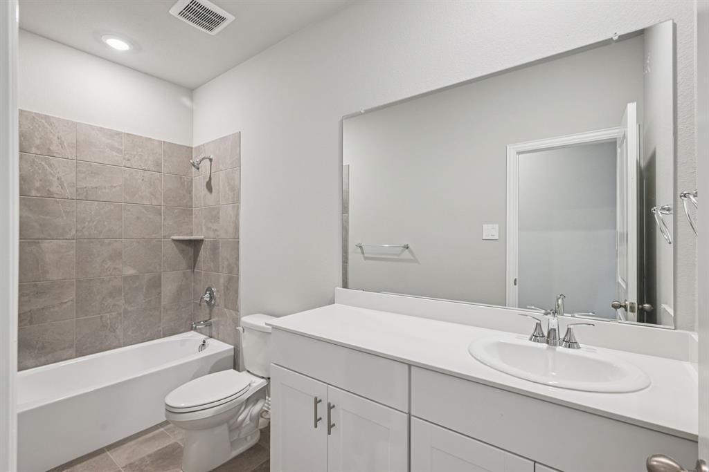 2112 Rannoch Street Sherman, TX 75092 - Photo 19 of 32 a bathroom with a sink a toilet and shower