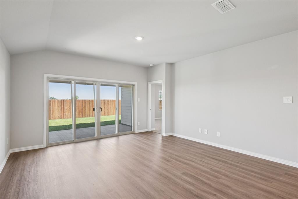 2112 Rannoch Street Sherman, TX 75092 - Photo 9 of 32 a view of an empty room with wooden floor and a window
