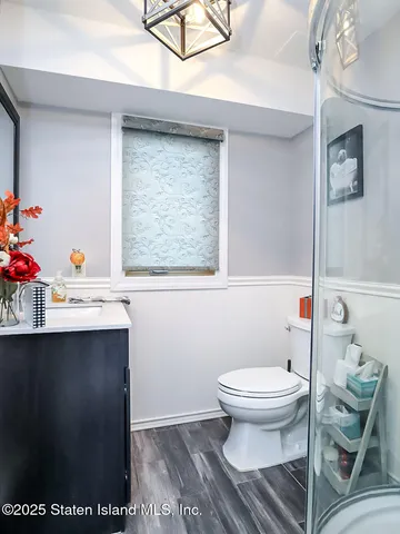 a bathroom with a sink toilet and a mirror