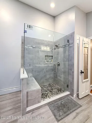 a bathroom with a glass shower door