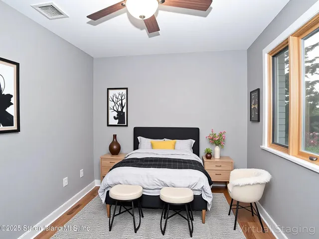 a bedroom with a bed and a table in it with window