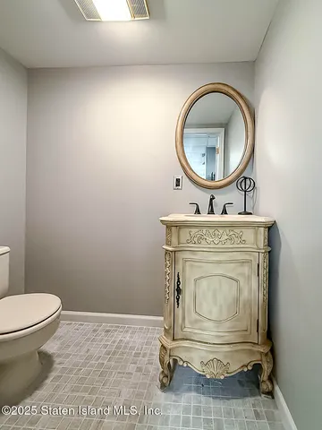a bathroom with a toilet a sink and a mirror