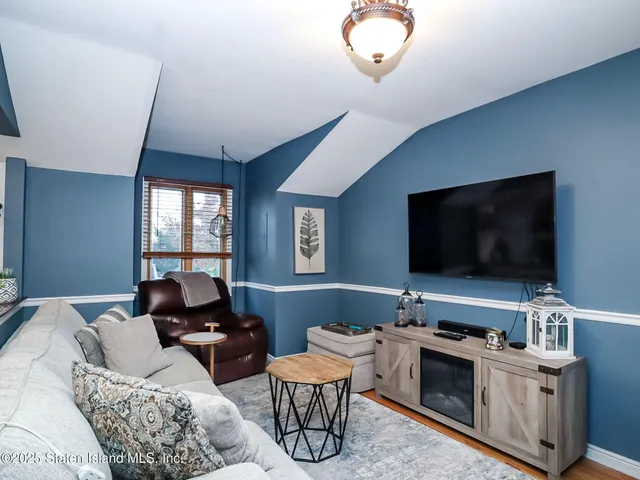 a hotel room with furniture and a flat screen tv