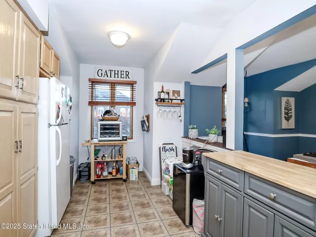 a room with furniture a flat screen tv and a sink
