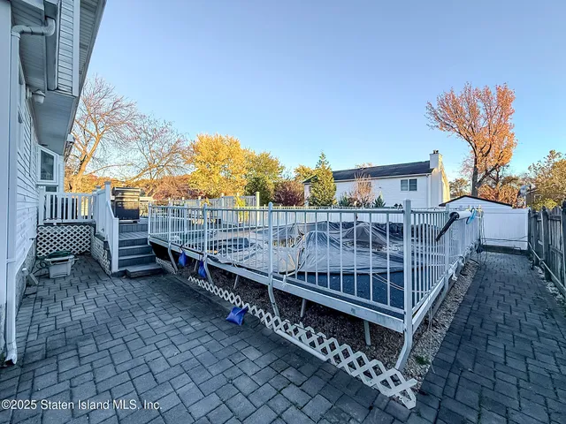 a view of roof deck with wooden floor and fence