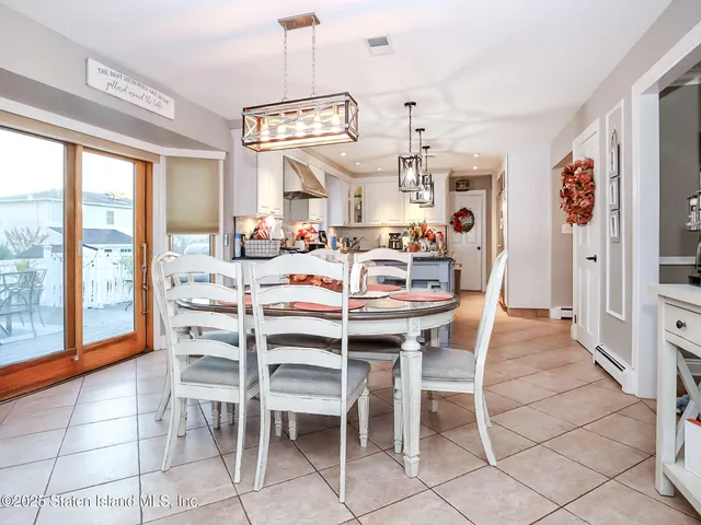 a view of a dining room with furniture large windows and wooden floor