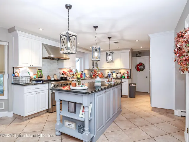 a kitchen with stainless steel appliances granite countertop a sink and cabinets