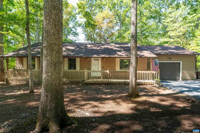 front view of a house with a tree in the yard