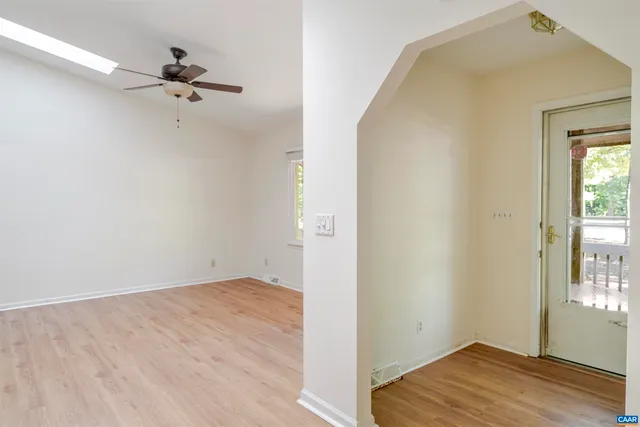 a view of a room with wooden floor closet and windows