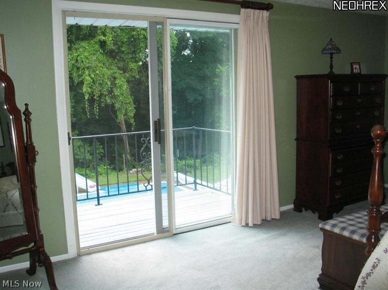7750 Pyle South Amherst Road Amherst, OH 44001 - Photo 17 of 24 Sliding Glass Doors in Master Bedroom to Balcony that Overlooks Pool
