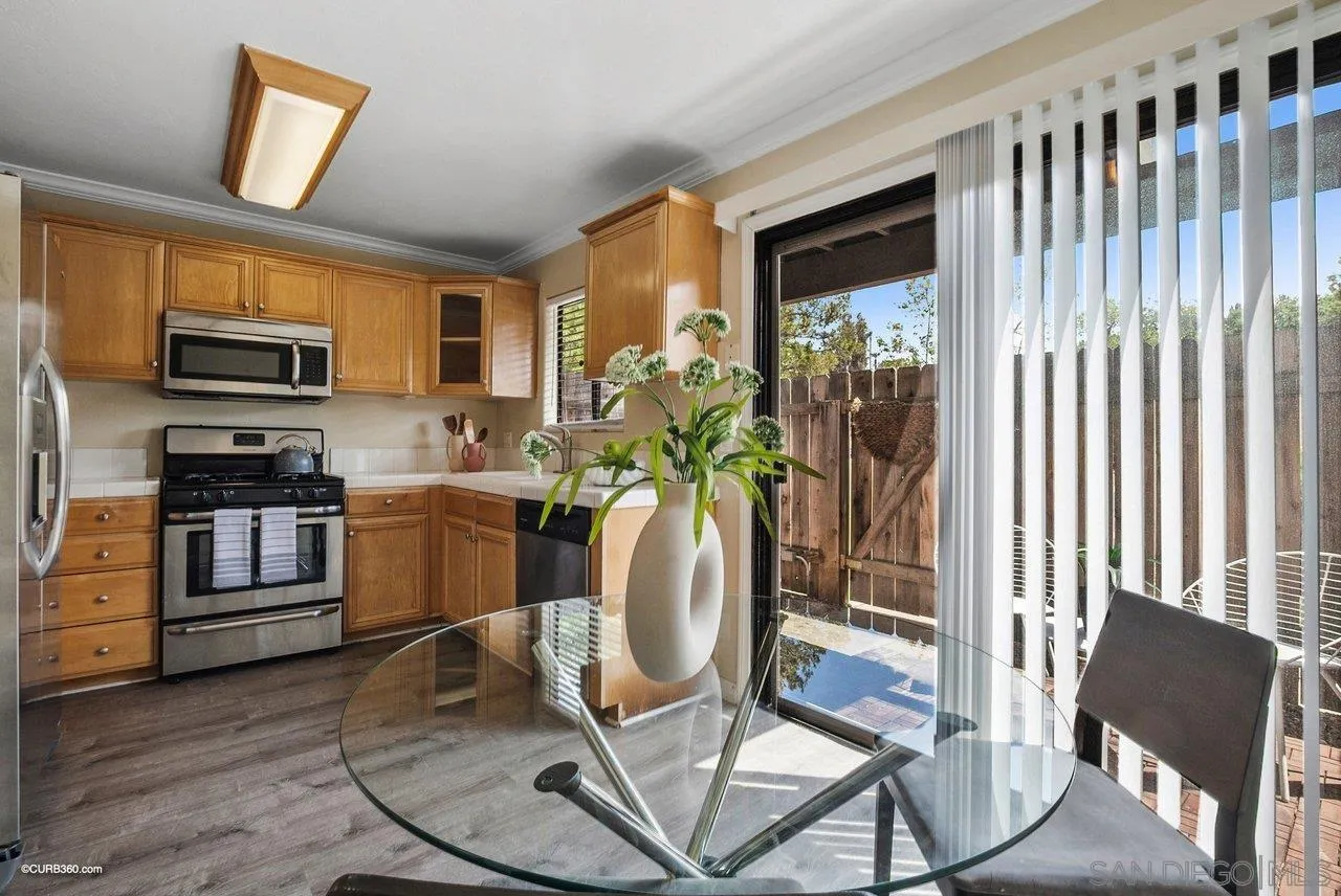 2648 Alpine Boulevard, Unit A Alpine, CA 91901 - Photo 11 of 30 a living room with furniture a flat screen tv and floor to ceiling window