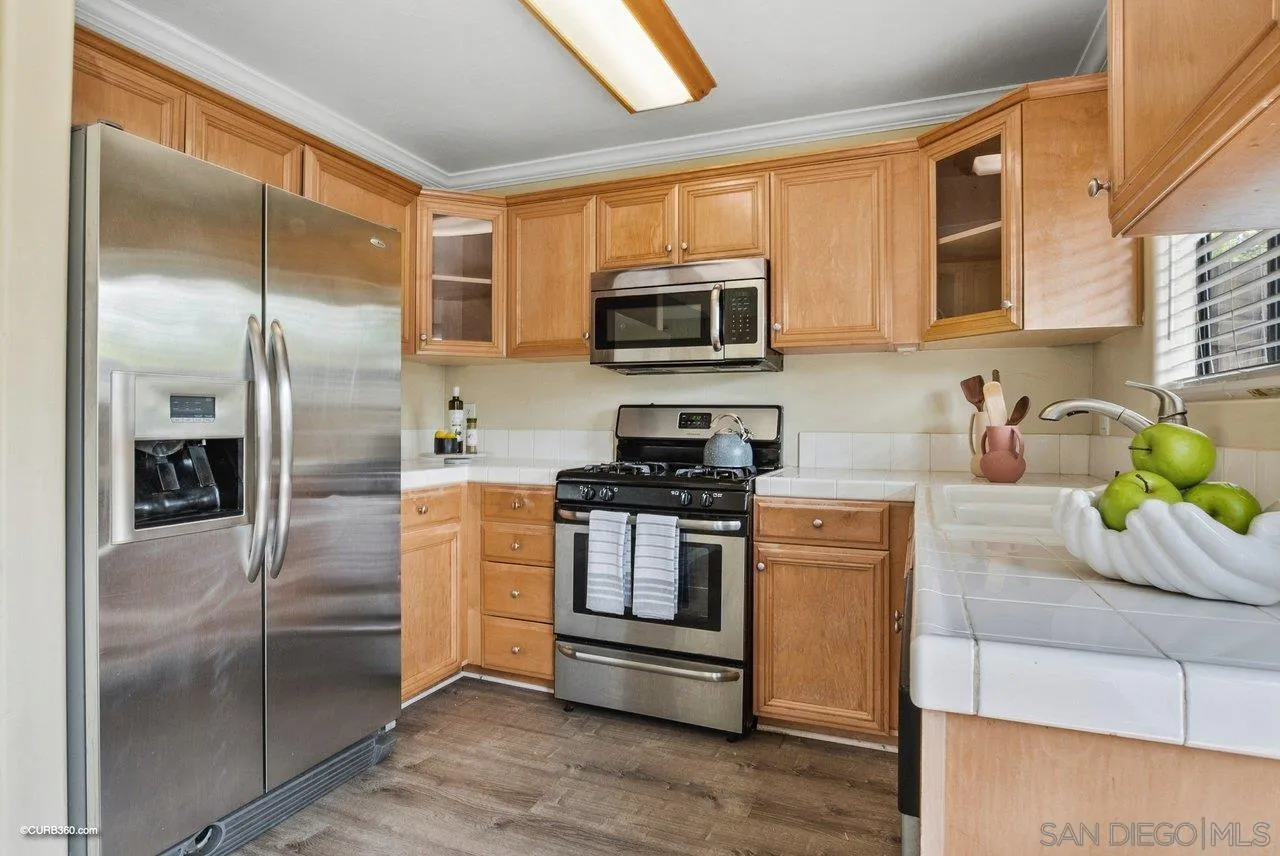 2648 Alpine Boulevard, Unit A Alpine, CA 91901 - Photo 13 of 30 a kitchen with stainless steel appliances granite countertop a refrigerator a stove top oven a sink and dishwasher