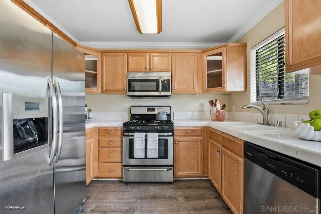 2648 Alpine Boulevard, Unit A Alpine, CA 91901 - Photo 14 of 30 a kitchen with stainless steel appliances granite countertop a stove a sink and a refrigerator