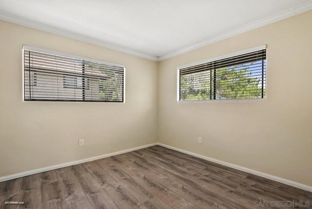 2648 Alpine Boulevard, Unit A Alpine, CA 91901 - Photo 21 of 30 a view of an empty room with wooden floor and a window