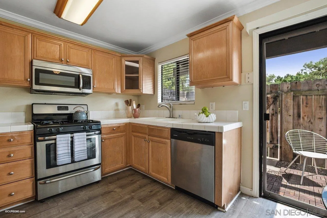 2648 Alpine Boulevard, Unit A Alpine, CA 91901 - Photo 10 of 30 a kitchen with stainless steel appliances a stove sink microwave and cabinets
