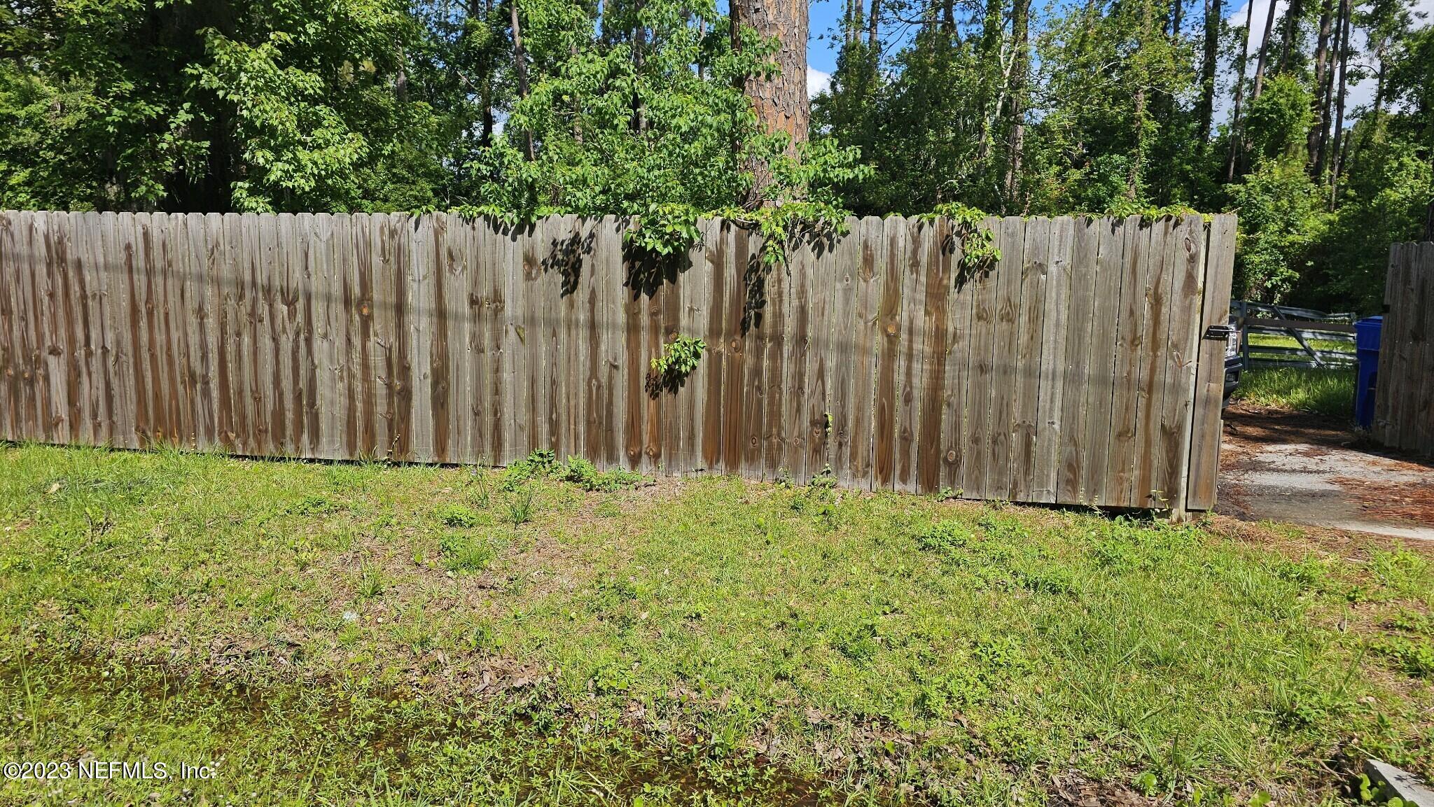 150 Venetian Boulevard St. Augustine, FL 32095 - Photo 16 of 17 a view of small yard with wooden fence