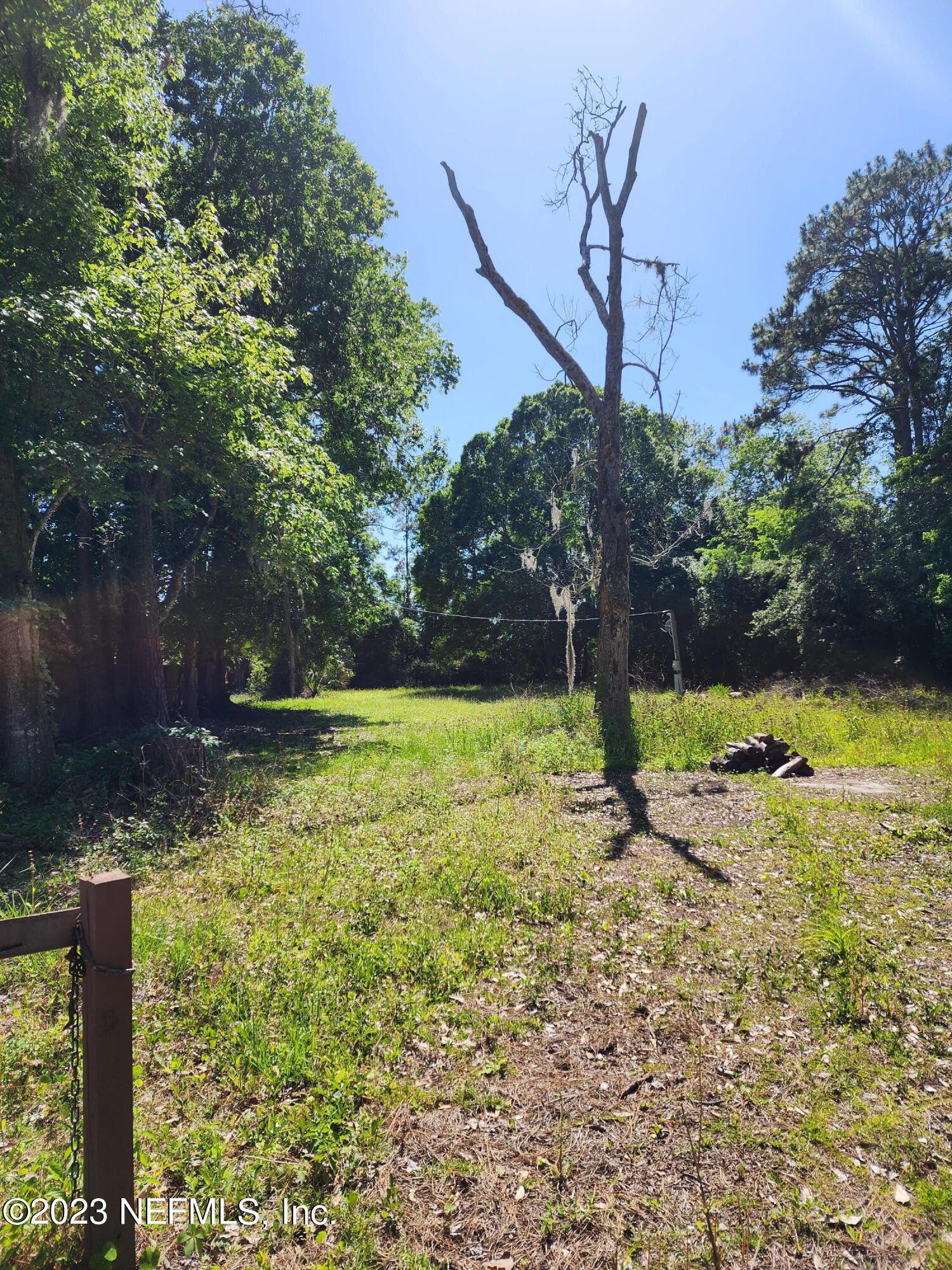 150 Venetian Boulevard St. Augustine, FL 32095 - Photo 2 of 17 a view of a yard with a tree