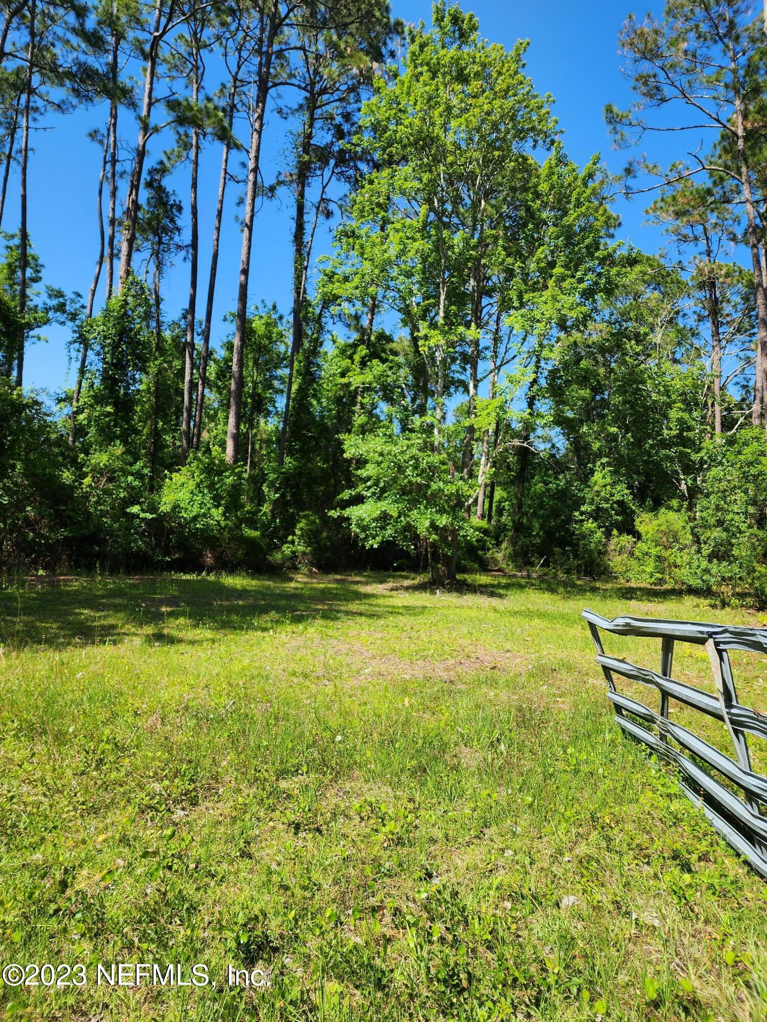 150 Venetian Boulevard St. Augustine, FL 32095 - Photo 3 of 17 a view of a yard with a bench