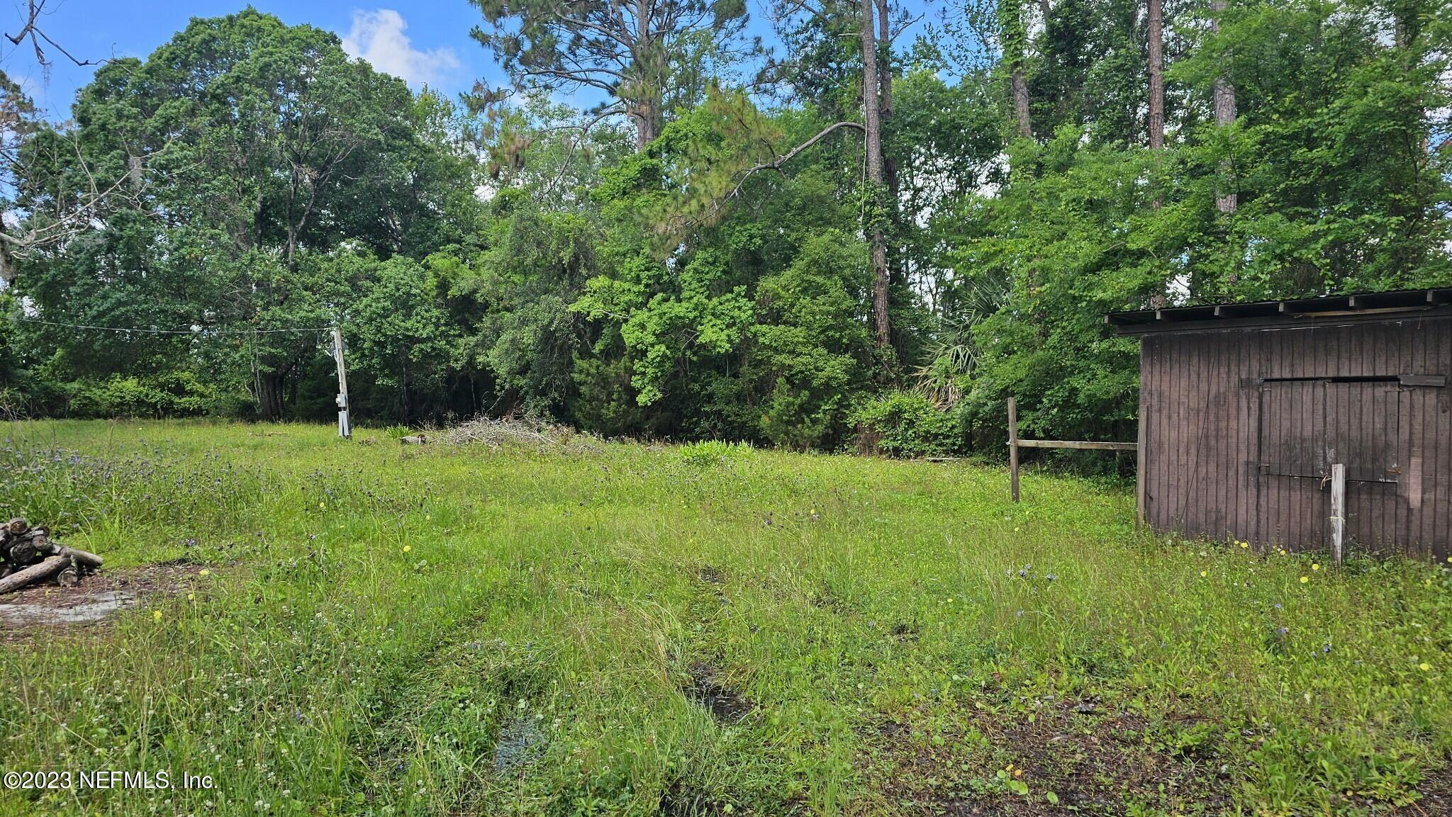 150 Venetian Boulevard St. Augustine, FL 32095 - Photo 4 of 17 a backyard of a house with lots of green space
