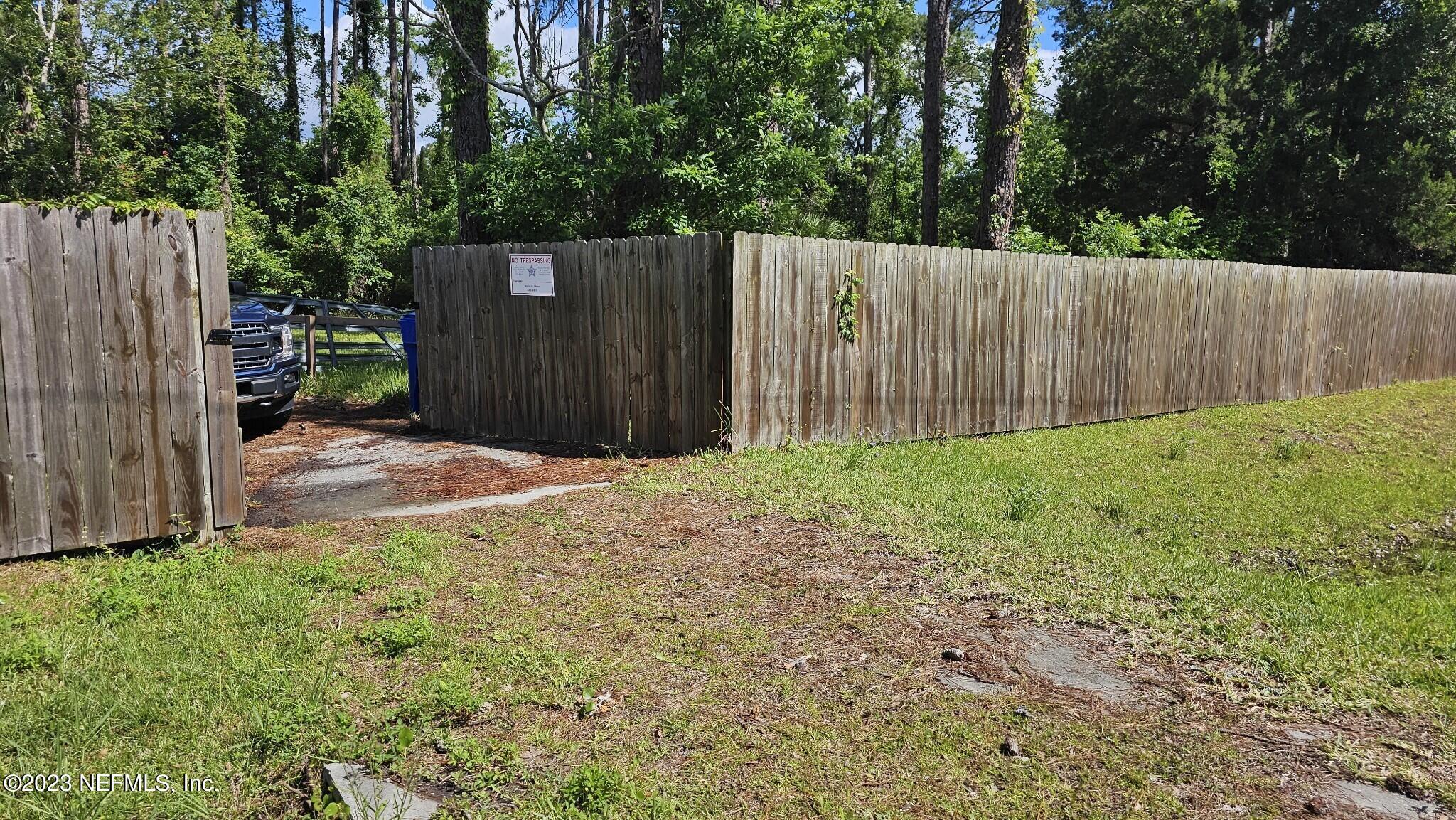 150 Venetian Boulevard St. Augustine, FL 32095 - Photo 8 of 17 a view of backyard with wooden fence