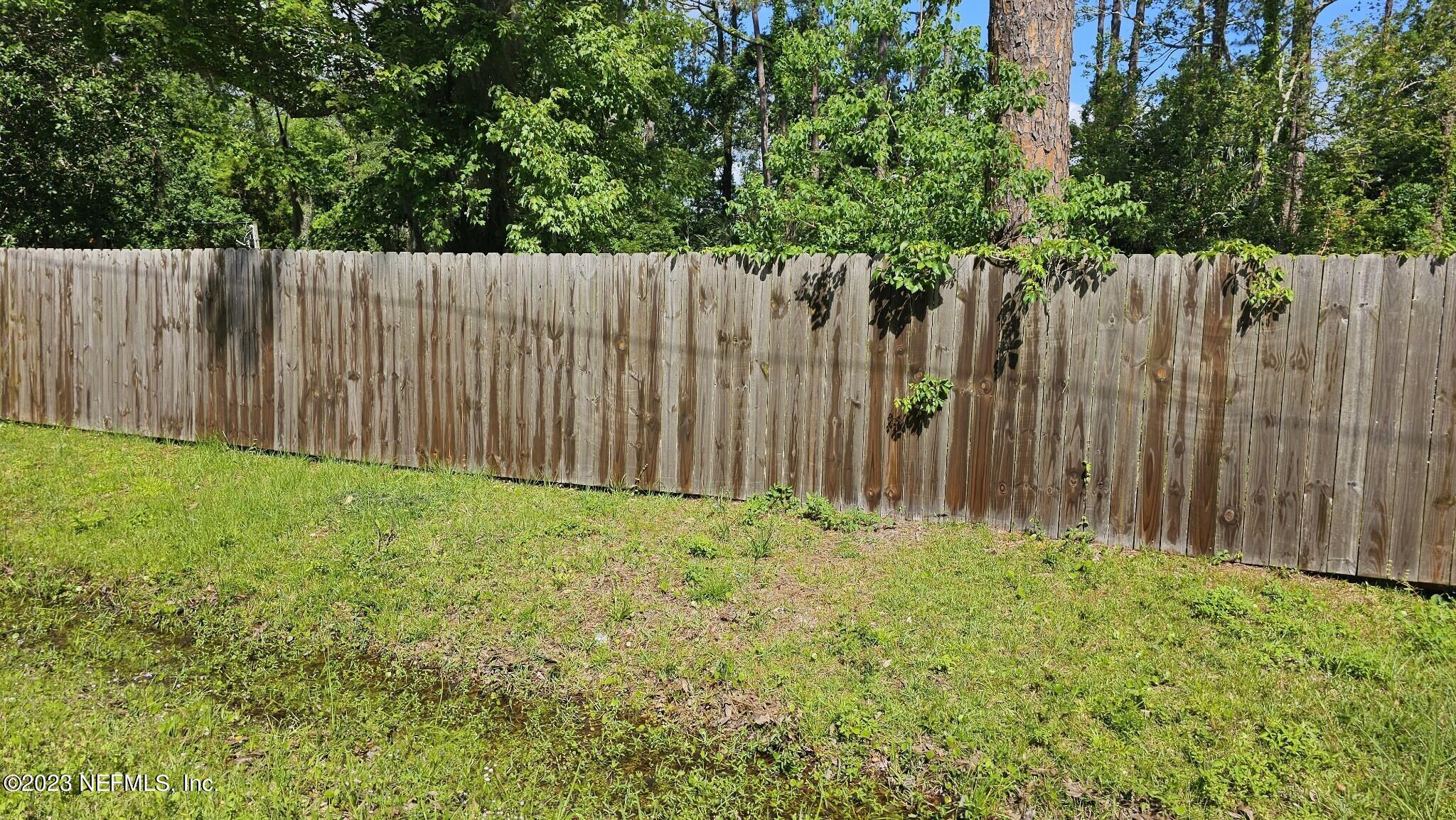 150 Venetian Boulevard St. Augustine, FL 32095 - Photo 9 of 17 a view of a backyard with wooden fence