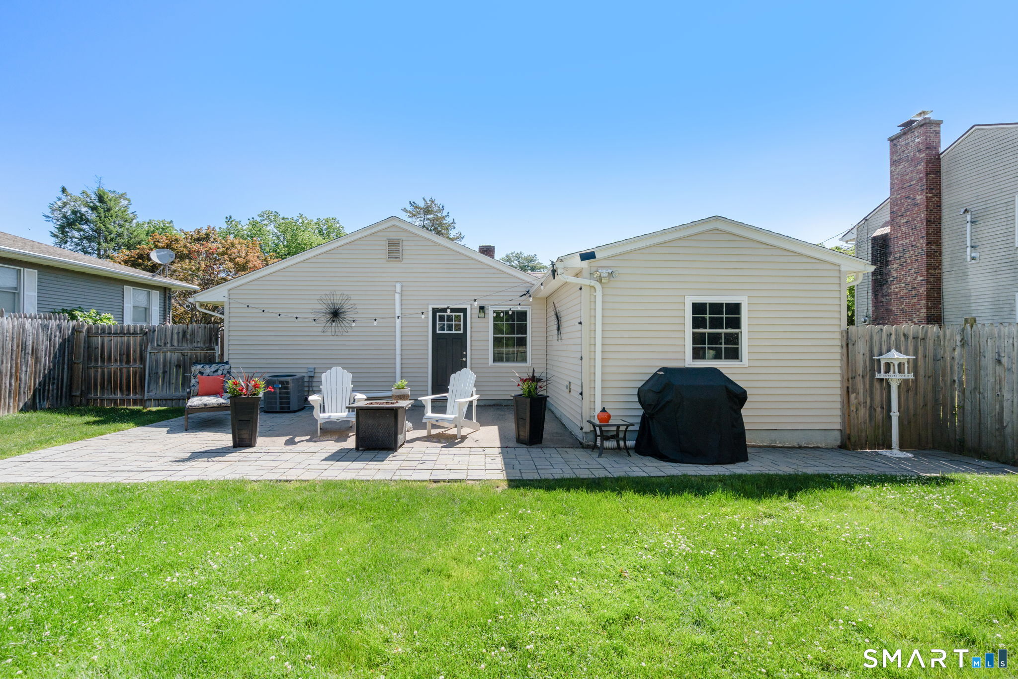 31 Cowan Street Suffield, CT 06078 - Photo 27 of 29 a view of backyard with table and chairs and wooden fence