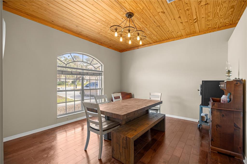 3030 South Bay Berry Point Inverness, FL 34450 - Photo 11 of 48 a view of a dining room with furniture a chandelier and wooden floor