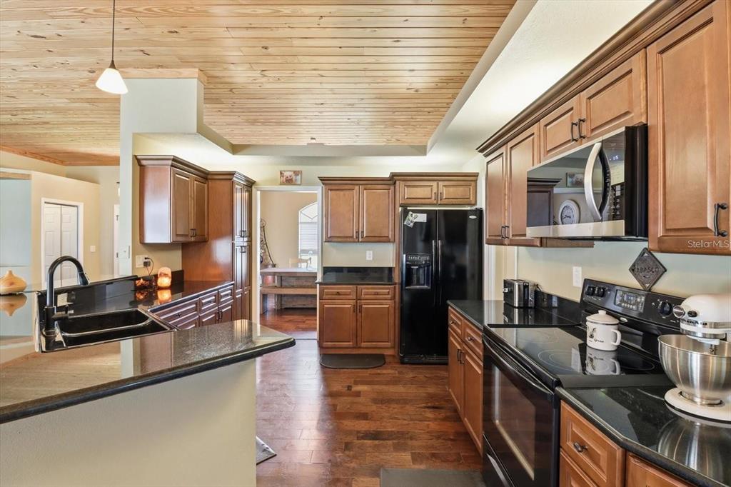 3030 South Bay Berry Point Inverness, FL 34450 - Photo 15 of 48 a kitchen with refrigerator cabinets and a sink