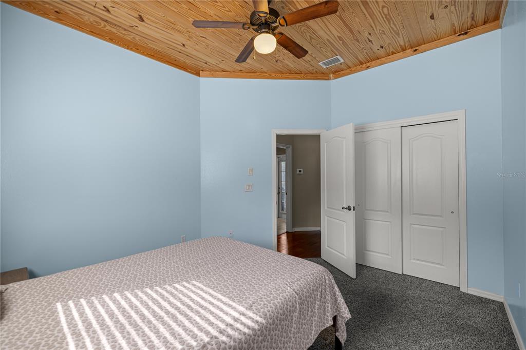 3030 South Bay Berry Point Inverness, FL 34450 - Photo 30 of 48 a bedroom with a bed and a chandelier fan