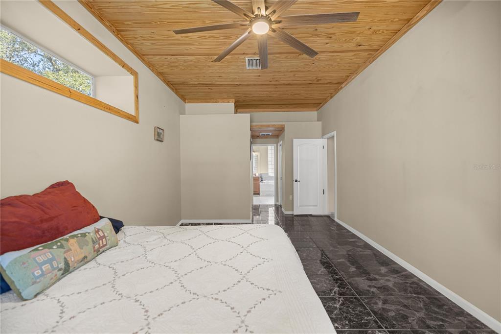 3030 South Bay Berry Point Inverness, FL 34450 - Photo 32 of 48 a bedroom with a bed and a rug