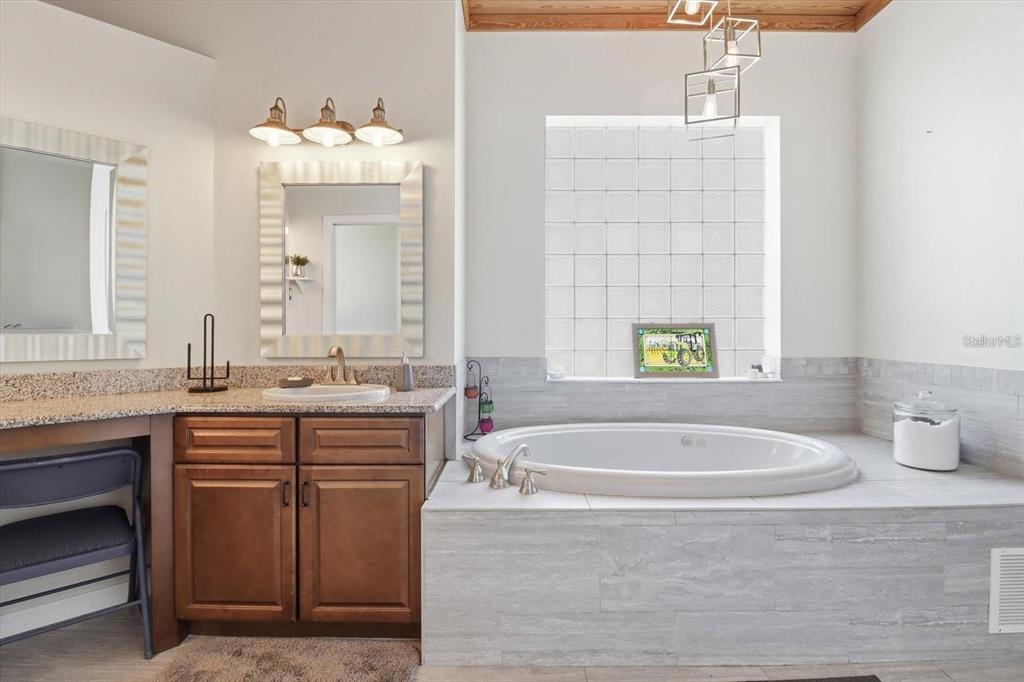 3030 South Bay Berry Point Inverness, FL 34450 - Photo 33 of 48 a spacious bathroom with sinks mirror and a bathtub