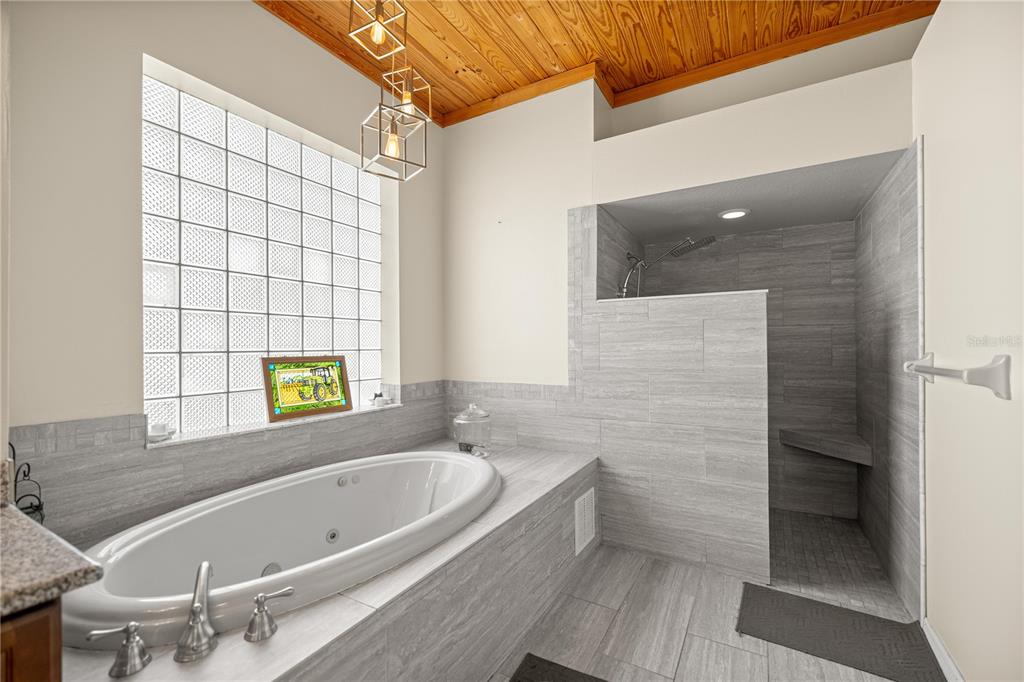 3030 South Bay Berry Point Inverness, FL 34450 - Photo 35 of 48 a bathroom with a tub and a shower