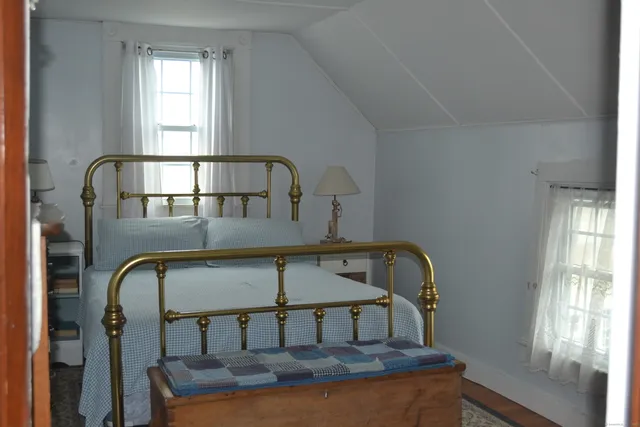 a bedroom with a bed and dresser
